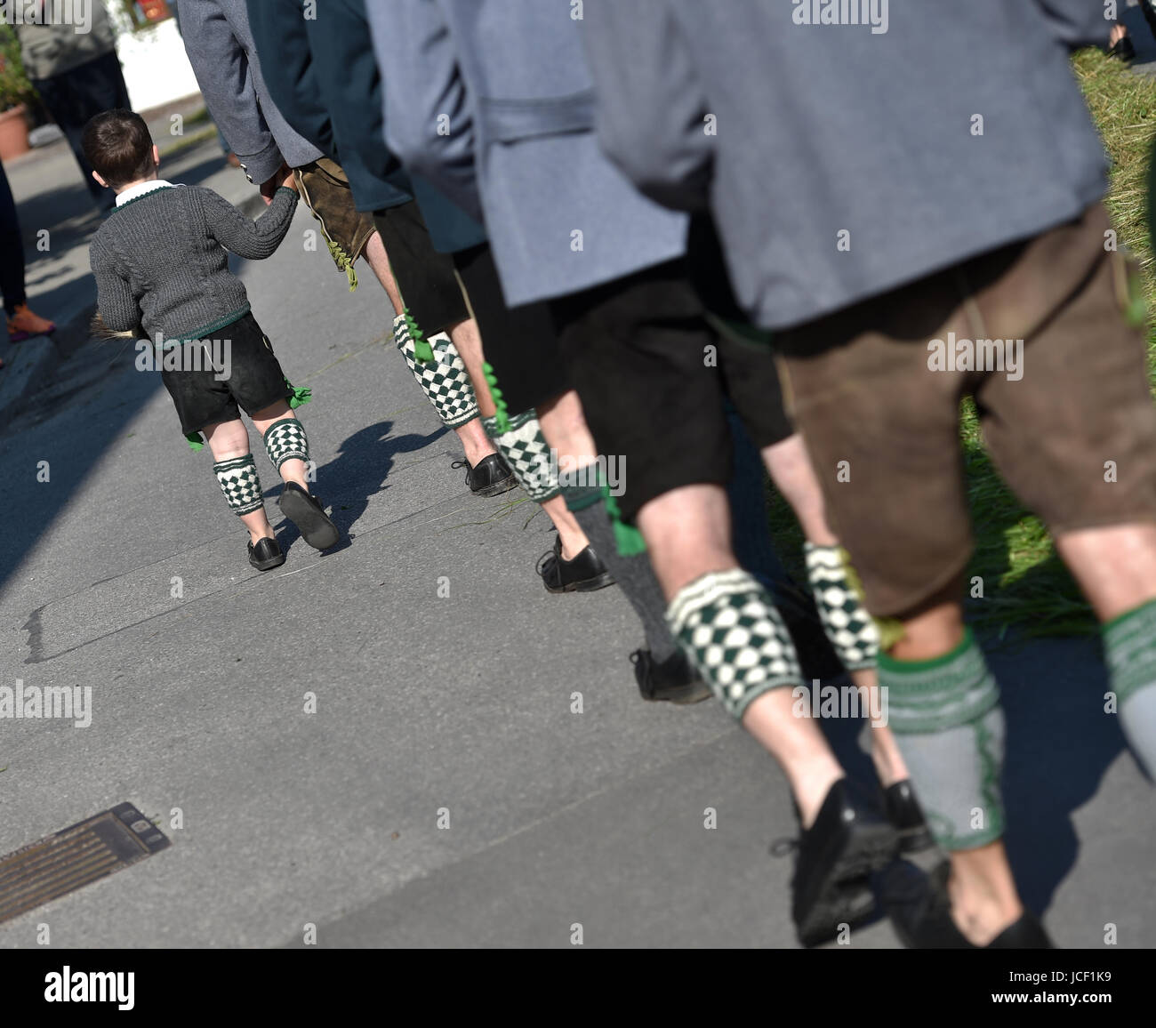 A boy walking with the Corpus Christi procession headed for Staffelsee lake, in Seehausen, Germany, 15 June 2017. Photo: Angelika Warmuth//dpa Stock Photo