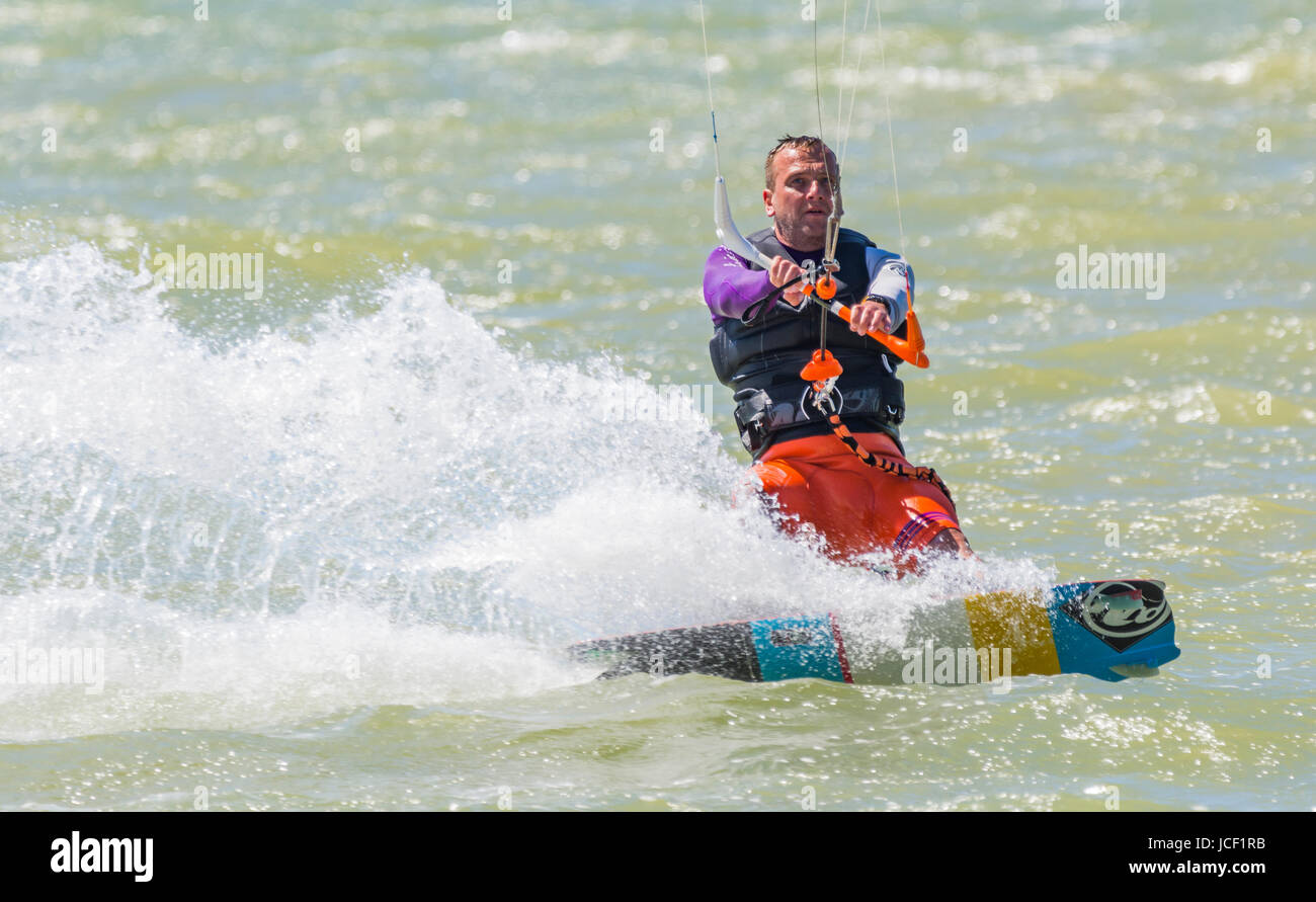 A man Kitesurfing at sea in Summer in the UK. Stock Photo