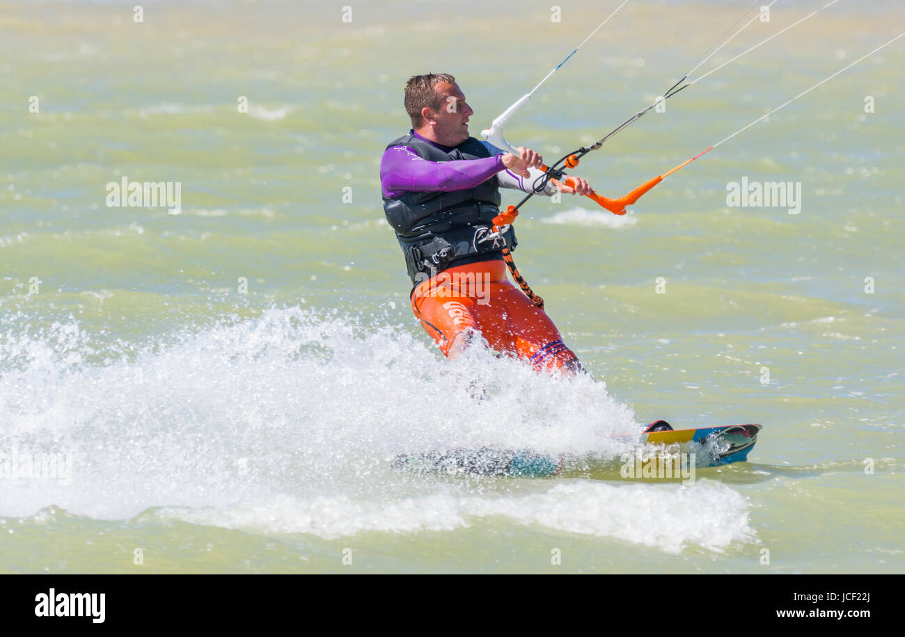 A man Kitesurfing at sea in Summer in the UK. Stock Photo