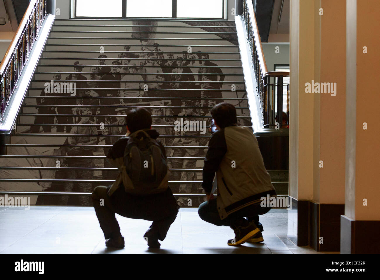 Edinburgh, Scotland, UK. 14th June 2017. Press viewing of Enduring Eye exhibition display in National Libray Scotland in Edinburgh. Pictured members of the public taking photos the photos print onto the stair as a part of the Eduring Eye exhibition. Pako Mera/Alamy Live News. Stock Photo