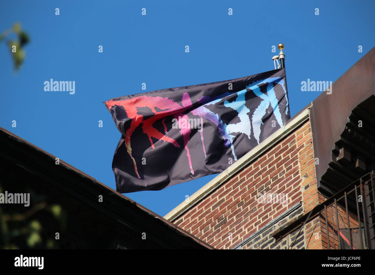 New York, USA. 14th June, 2017. At the East Village a flag of the artist Marilyn Minter which shows large, colourful letters "RESIST" in New York, USA, 14 June 2017. Photo: Christina Horsten/dpa/Alamy Live News Stock Photo
