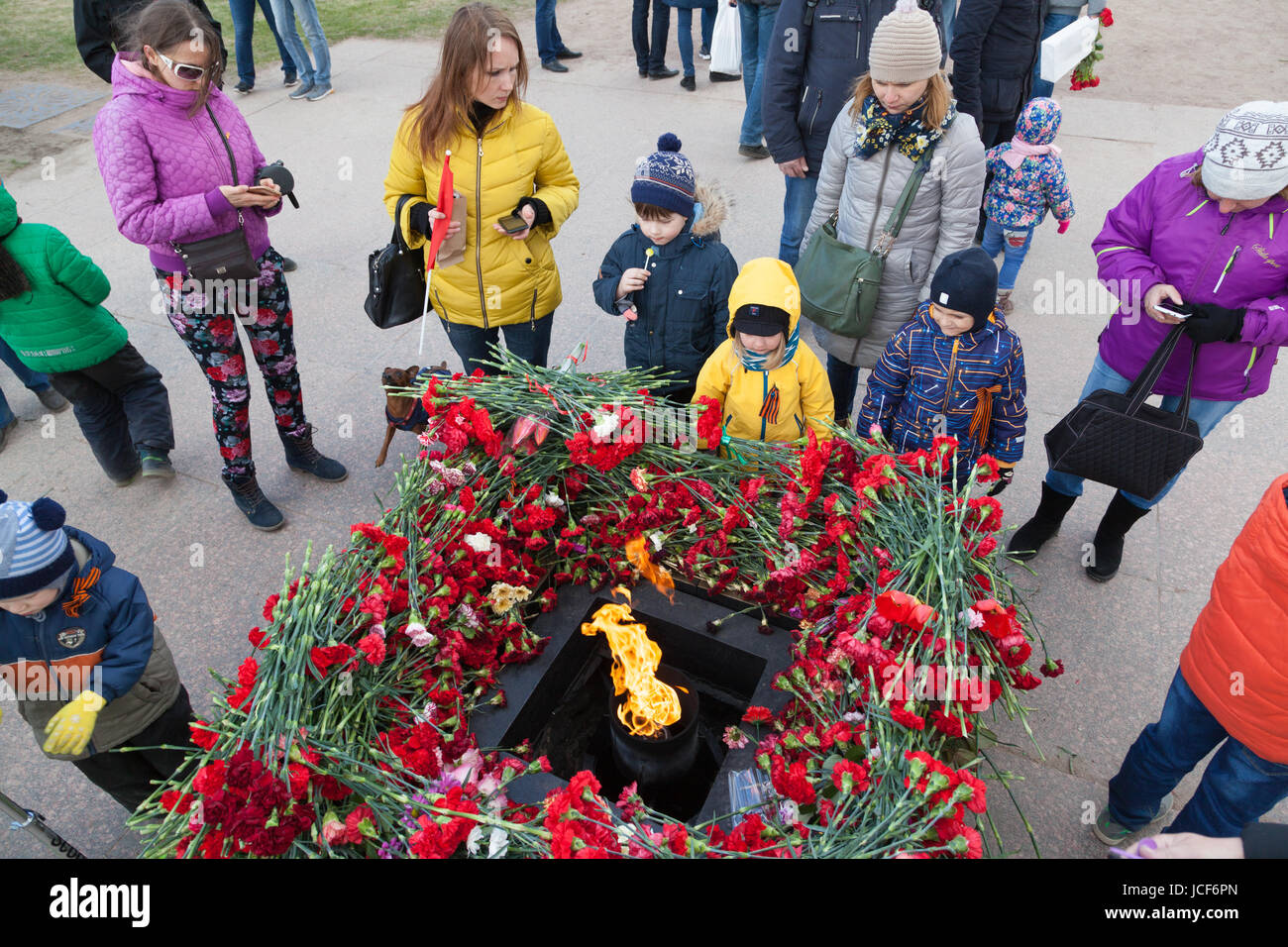 Laying flowers at the eternal fire on the Field of Mars Marsovo Polye on celebration of 72 anniv Victory day in the WWII Stock Photo