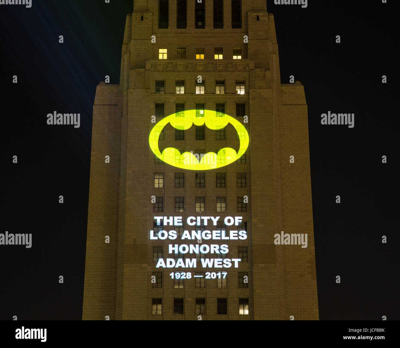 Los Angeles, California, USA. 15th June, 2017.  The City of Los Angeles honored the late actor Adam West, best known for his role as Batman, with a ceremonlal lighting of the Bat-Signal projected on City Hall in downtown Los Angeles on June 15th, 2017.  The Bat-Signal is an  iconic symbol of the Batman character and consists of a yellow oval light with a bat silhouette in the middle.  Credit:  Sheri Determan/Alamy Live News Stock Photo
