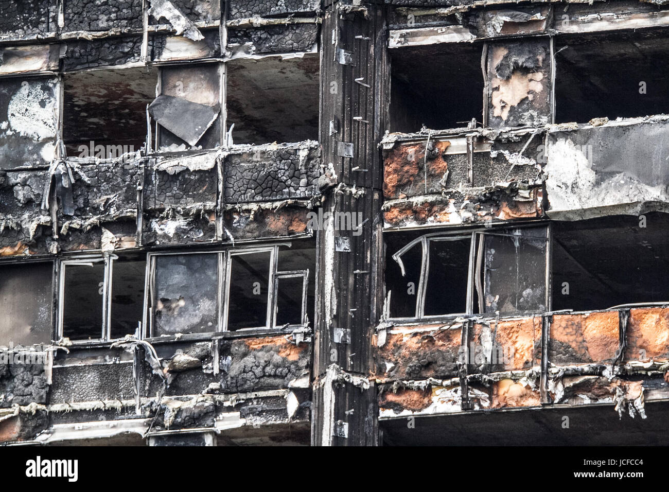 London, UK. 16th June, 2017. A close up of the the charred remains with melted cladding and blackened windows of the Grenfell residential tower block in Latimer road West London which was engulfed by a massive fire resulting in the deaths of 17 people and many still unaccounted for Credit: amer ghazzal/Alamy Live News Stock Photo