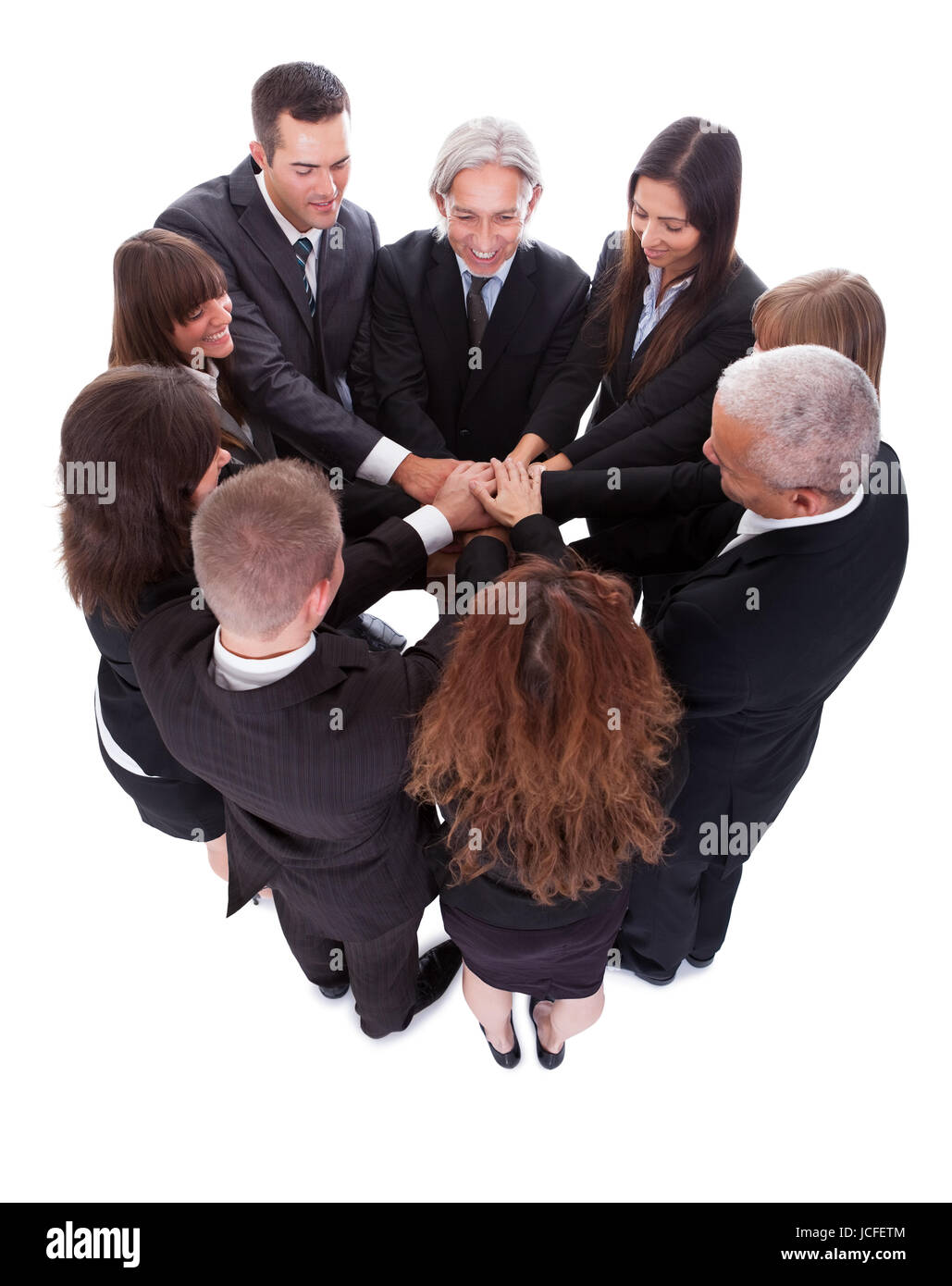 High angle view of a diverse group of people in a business team with their hands one on top of the other Stock Photo