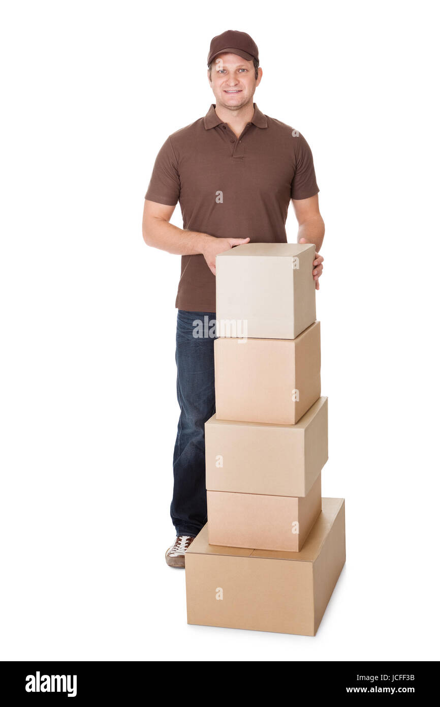 Portrait of delivery man with stack of boxes. Isolated on white ...