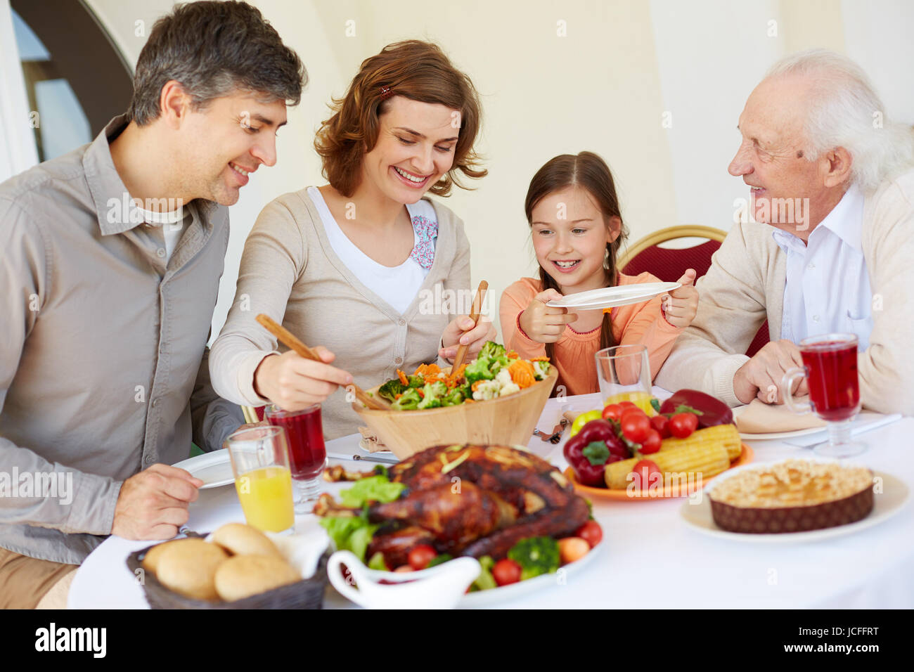Portrait of happy family having Thanksgiving dinner Stock Photo - Alamy