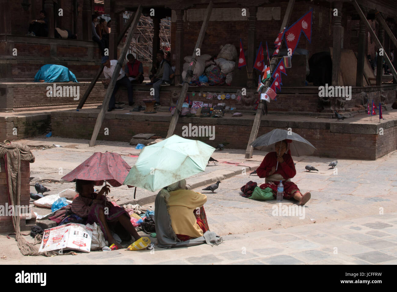 Ladies shading themselves from the sun under umbrellas on Durbar Square
