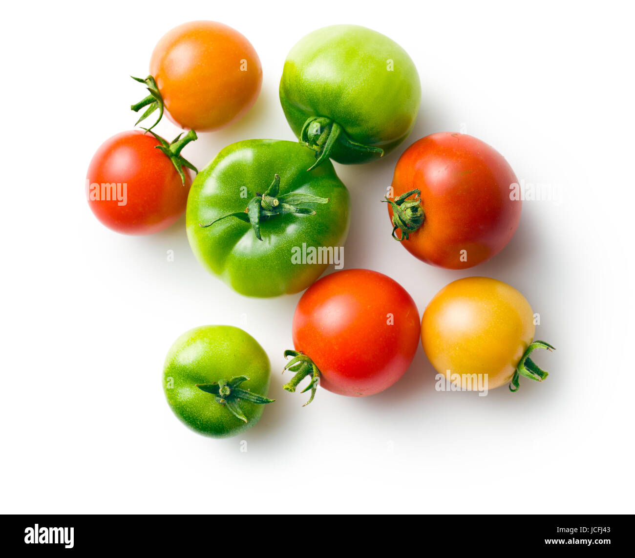 green and red tomatoes on white background Stock Photo - Alamy