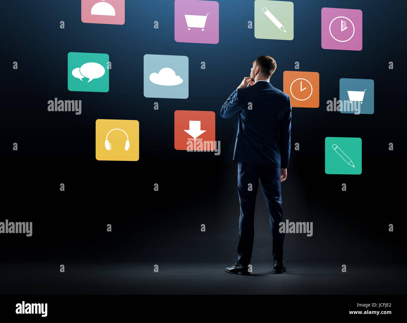 businessman in suit looking at virtual menu icons Stock Photo