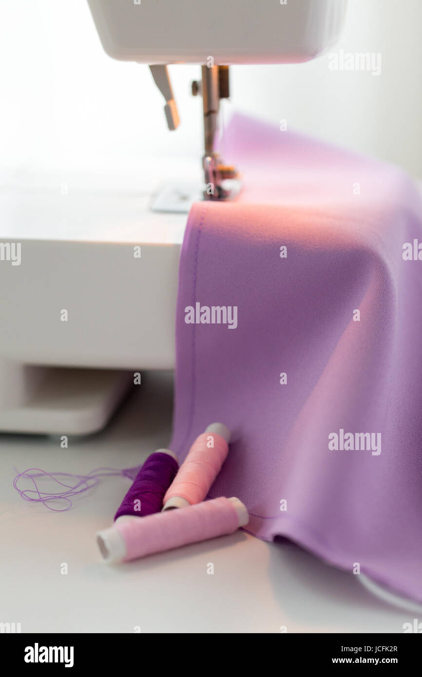 sewing machine, spools of thread and fabric Stock Photo Alamy