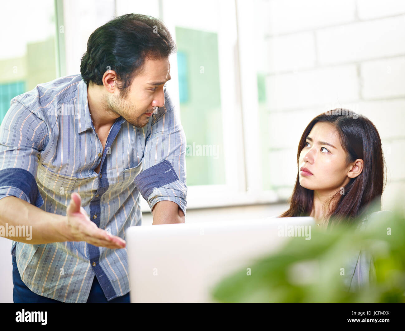 young asian corporate people having an argument in office. Stock Photo