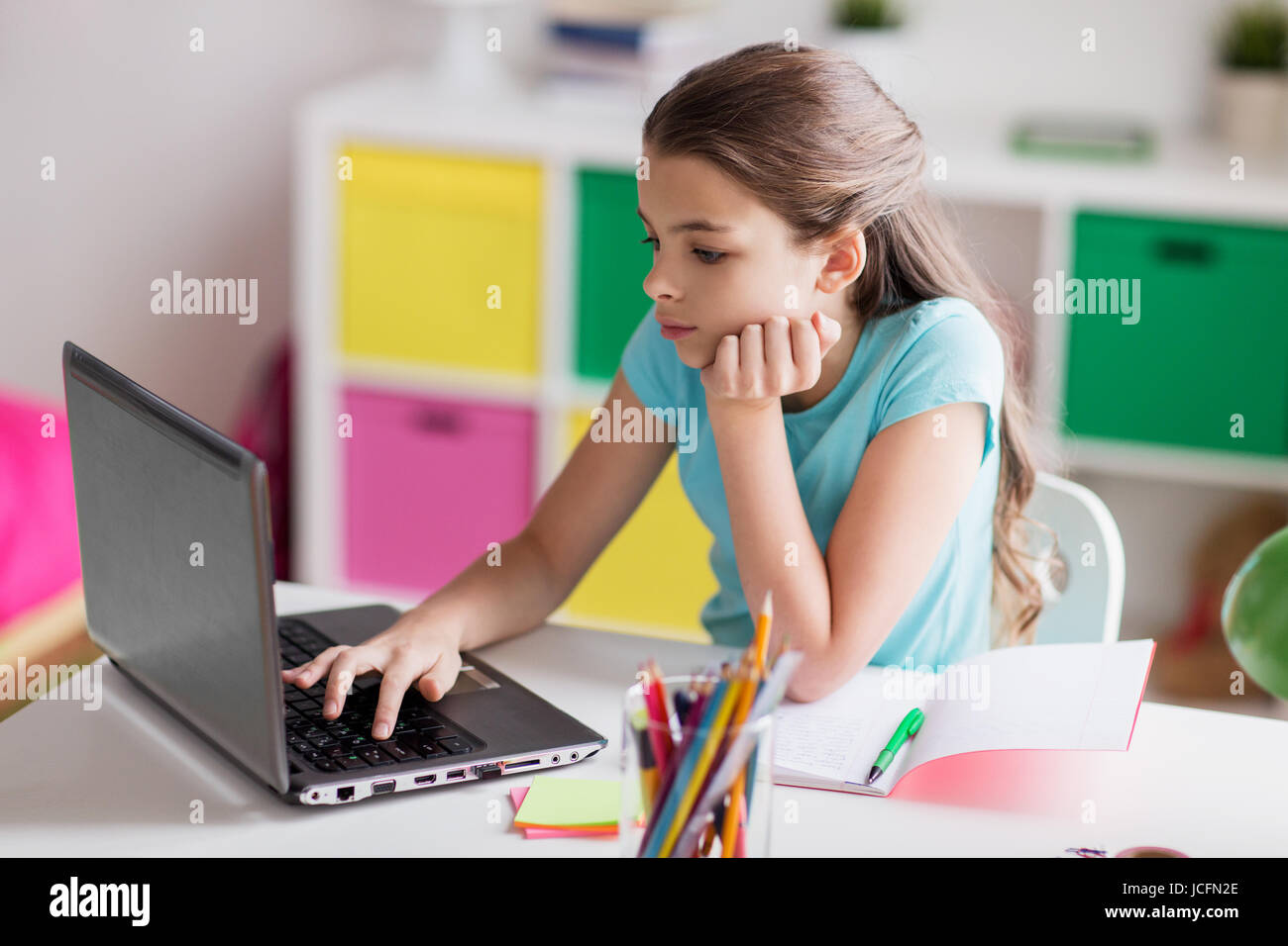 bored girl with laptop and notebook at home Stock Photo - Alamy