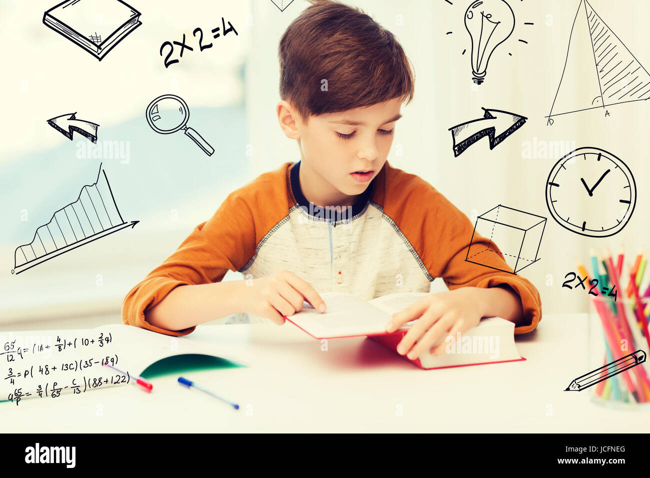 student boy reading book or textbook at home Stock Photo