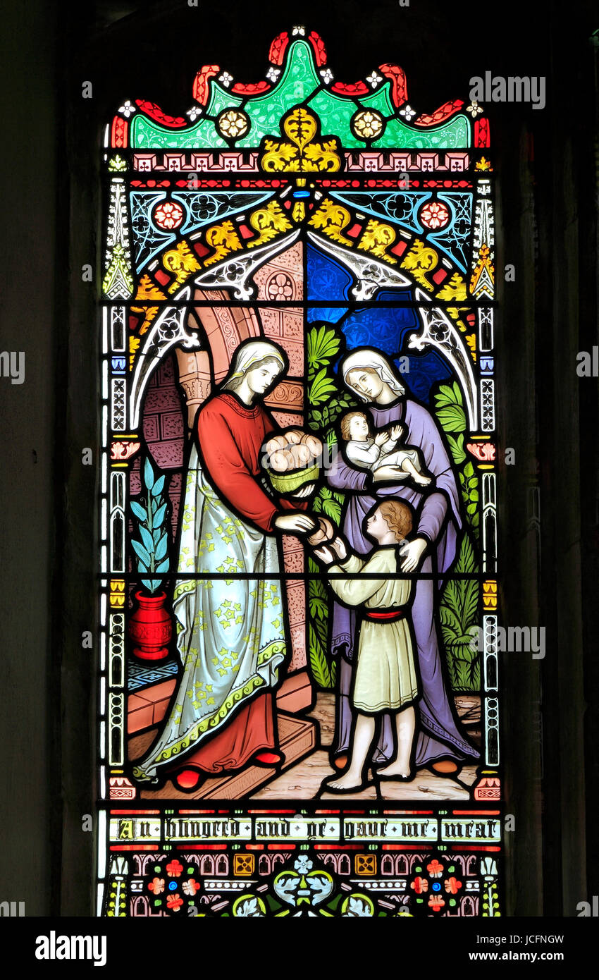 Corporal Acts of Mercy window, stained glass by Frederick Preedy, 1868, feeding the hungry, Gunthorpe, Norfolk, England, UK Stock Photo