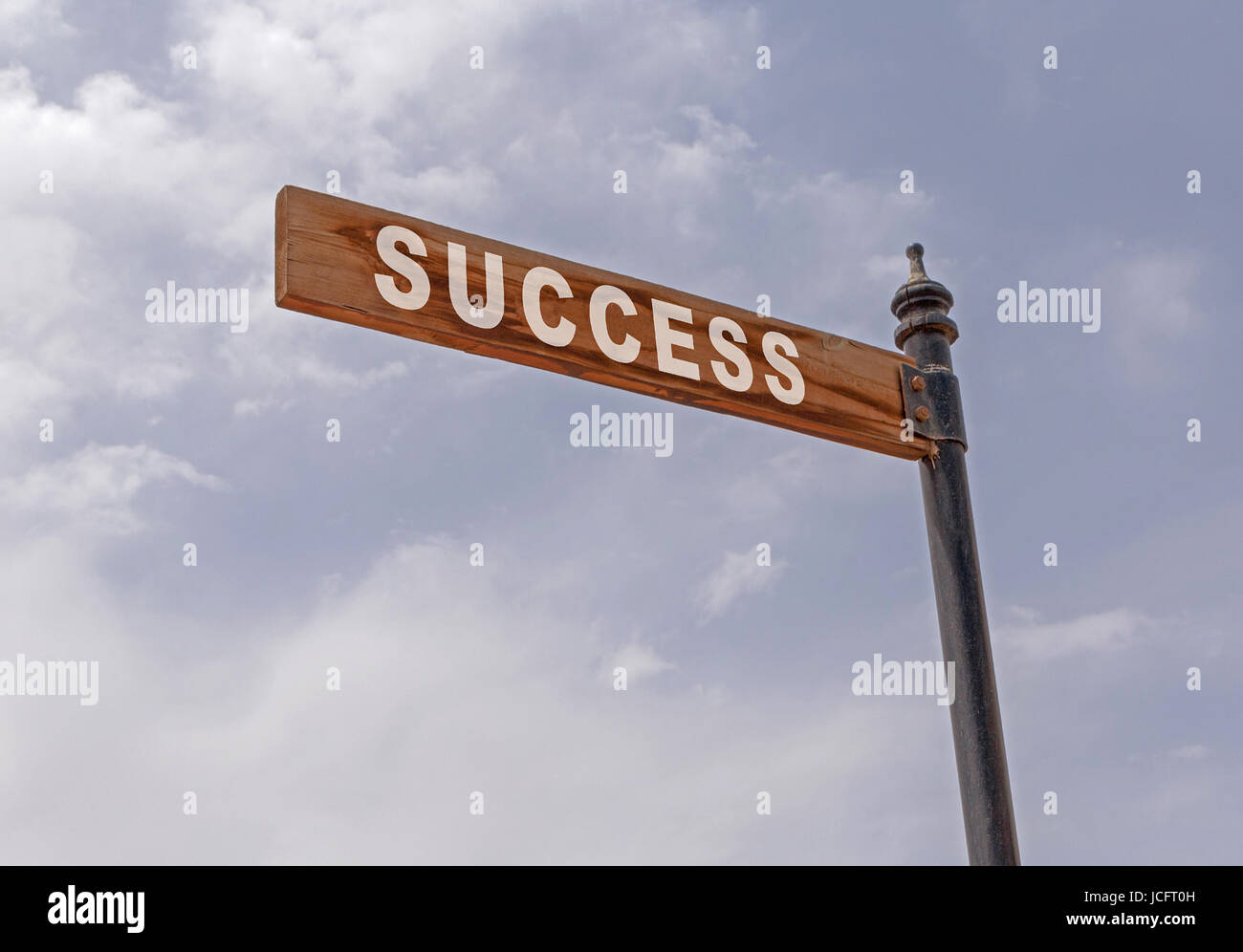 success pointer on pole against cloudy sky Stock Photo - Alamy
