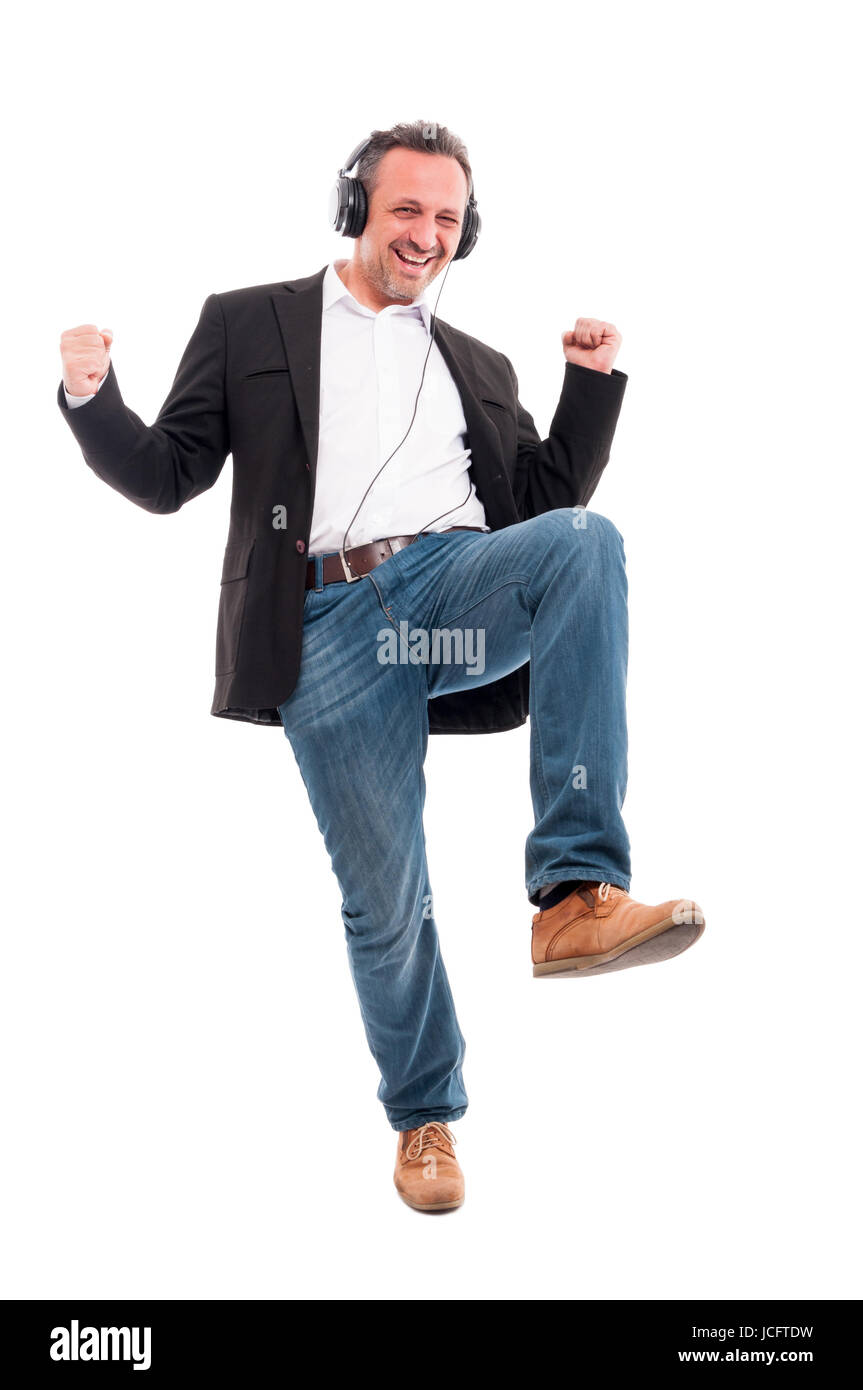 Happy man listening music on stereo headphones and dancing while having good mood Stock Photo