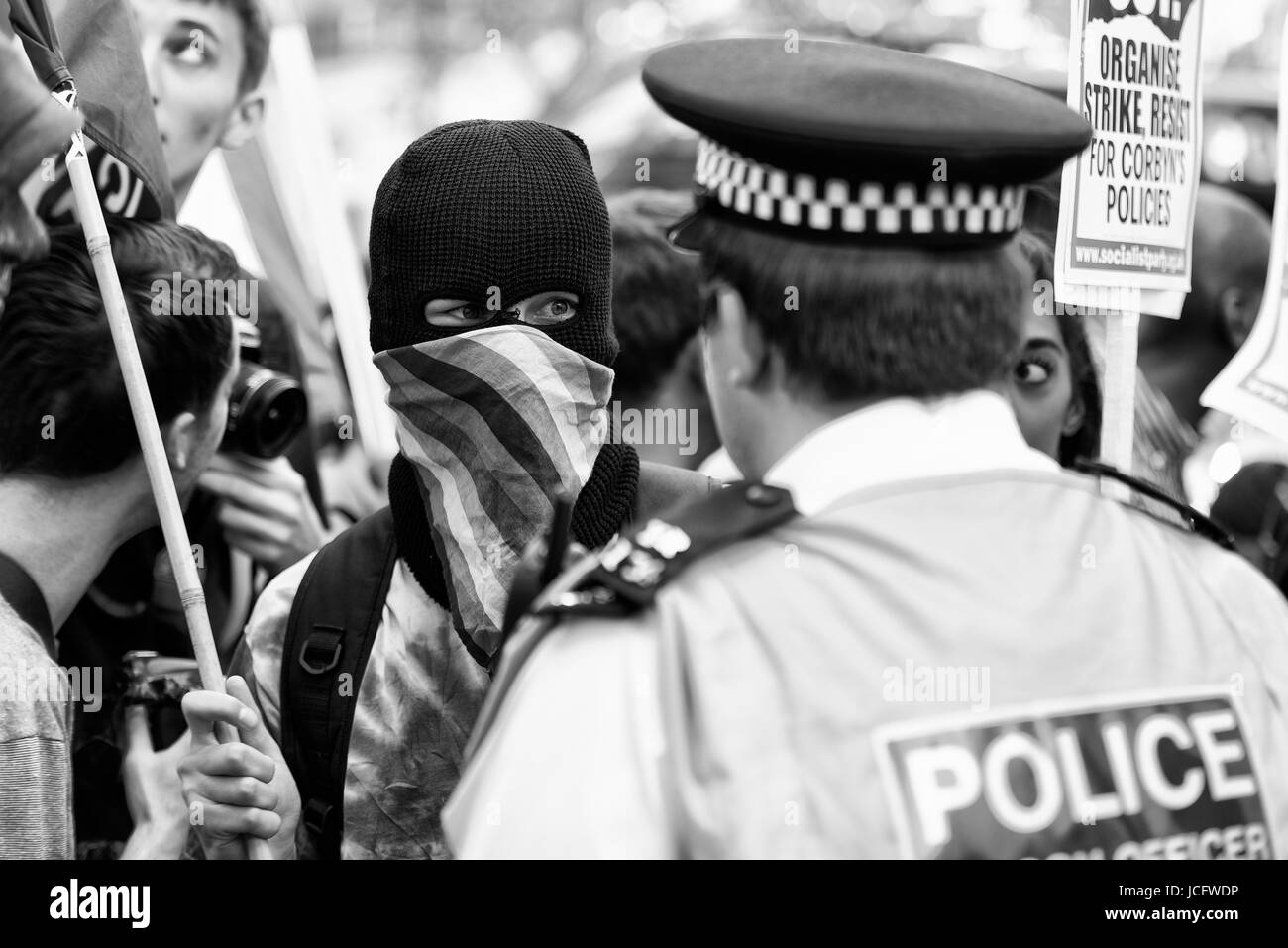 Demonstrators in Whitehall outside Downing Street in confrontational mood. Black & white. Monochrome Stock Photo