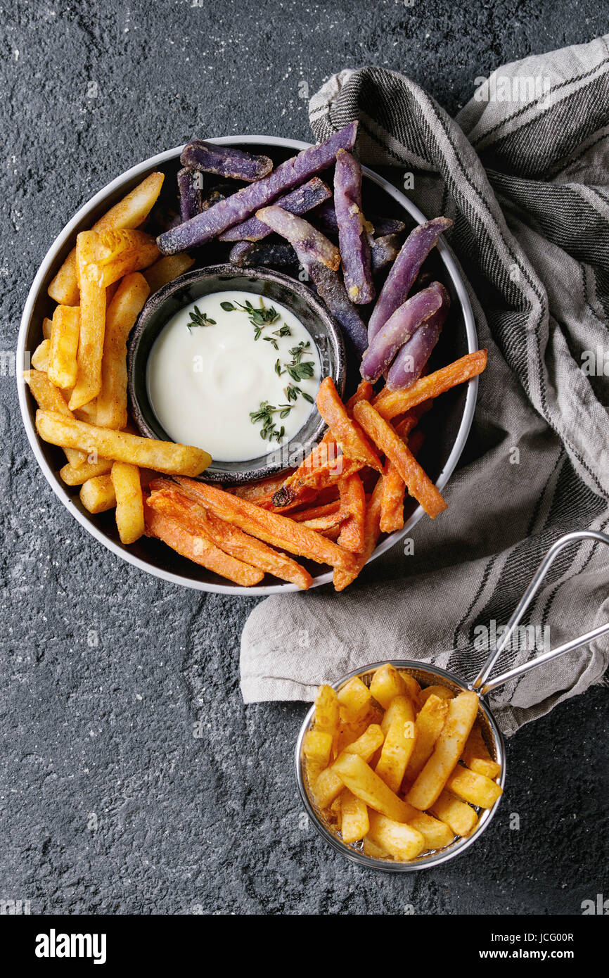 Variety of french fries traditional potatoes, purple potato, carrot