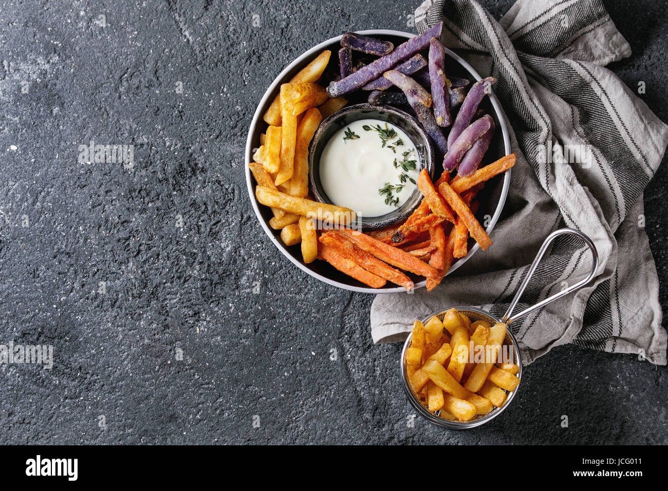 Variety of french fries traditional potatoes, purple potato, carrot