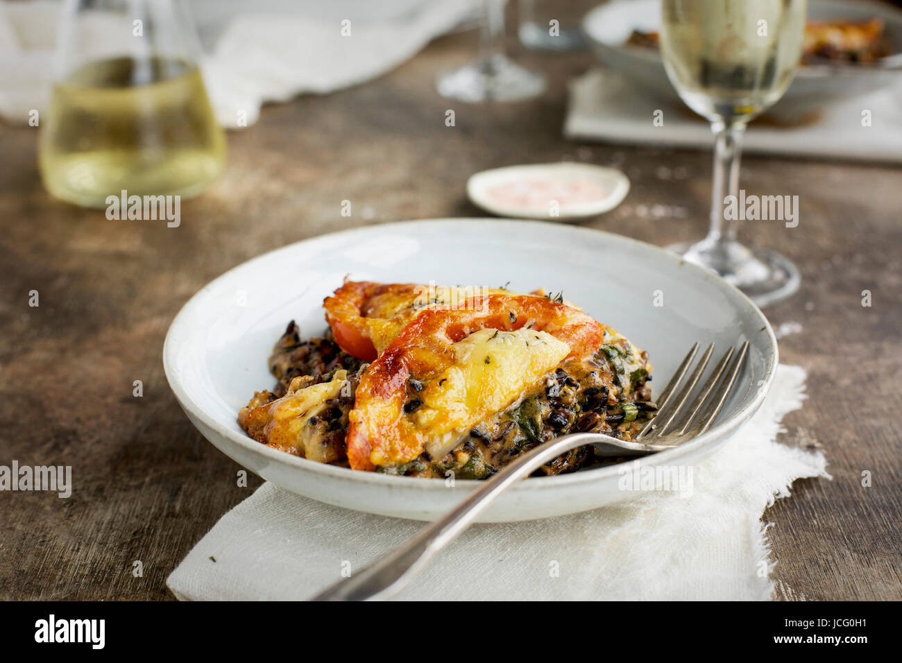 Wild Rice Kale Tomato Casserole with a Cheddar Cheese Sause served with