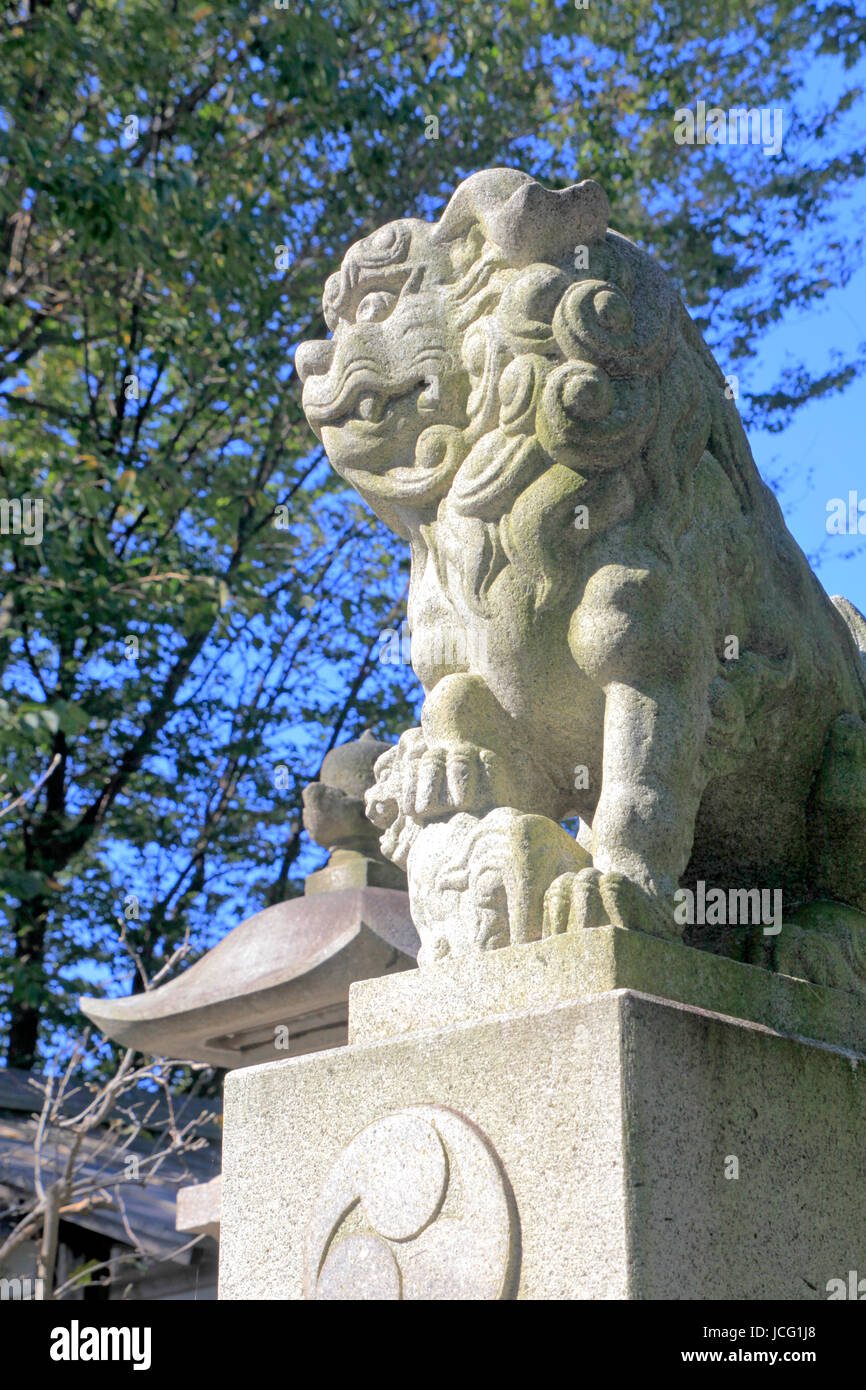 A Guardian Dog Statue at Azusami-Tenjin-sha Shinto Shrine in Tachikawa city Tokyo Japan Stock Photo