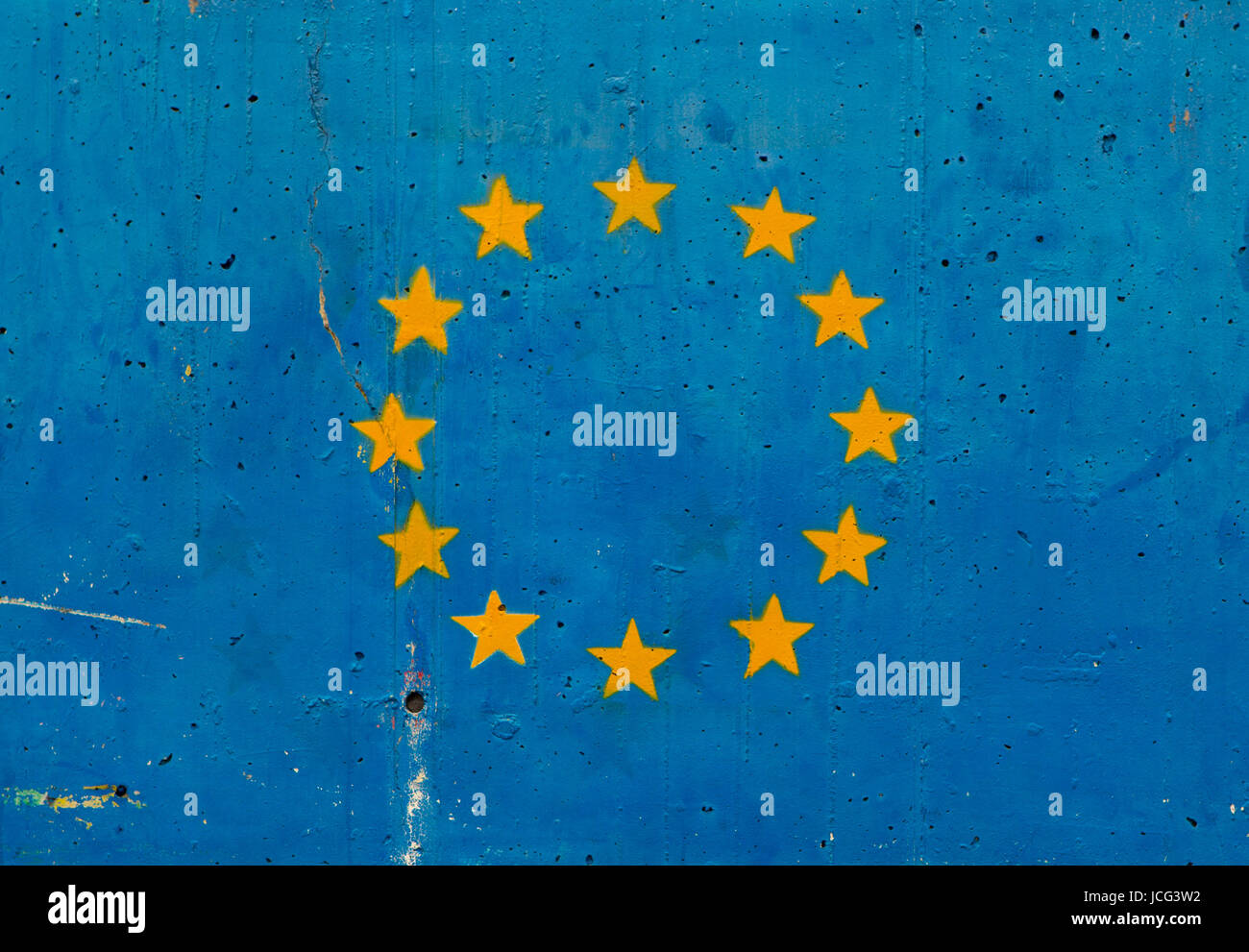 Yellow stars on blue concrete wall representing the European Union flag ...