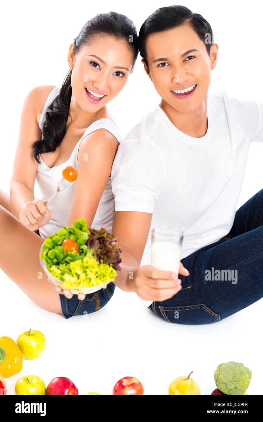 Asian couple eating salad fruit and vegetables Stock Photo - Alamy