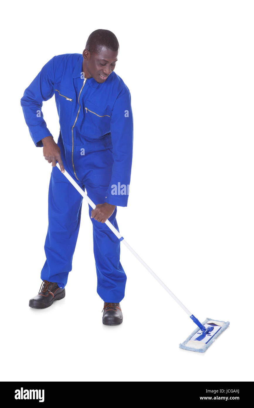 Young Man In Blue Boiler Suit Holding Mop Over White Background Stock Photo