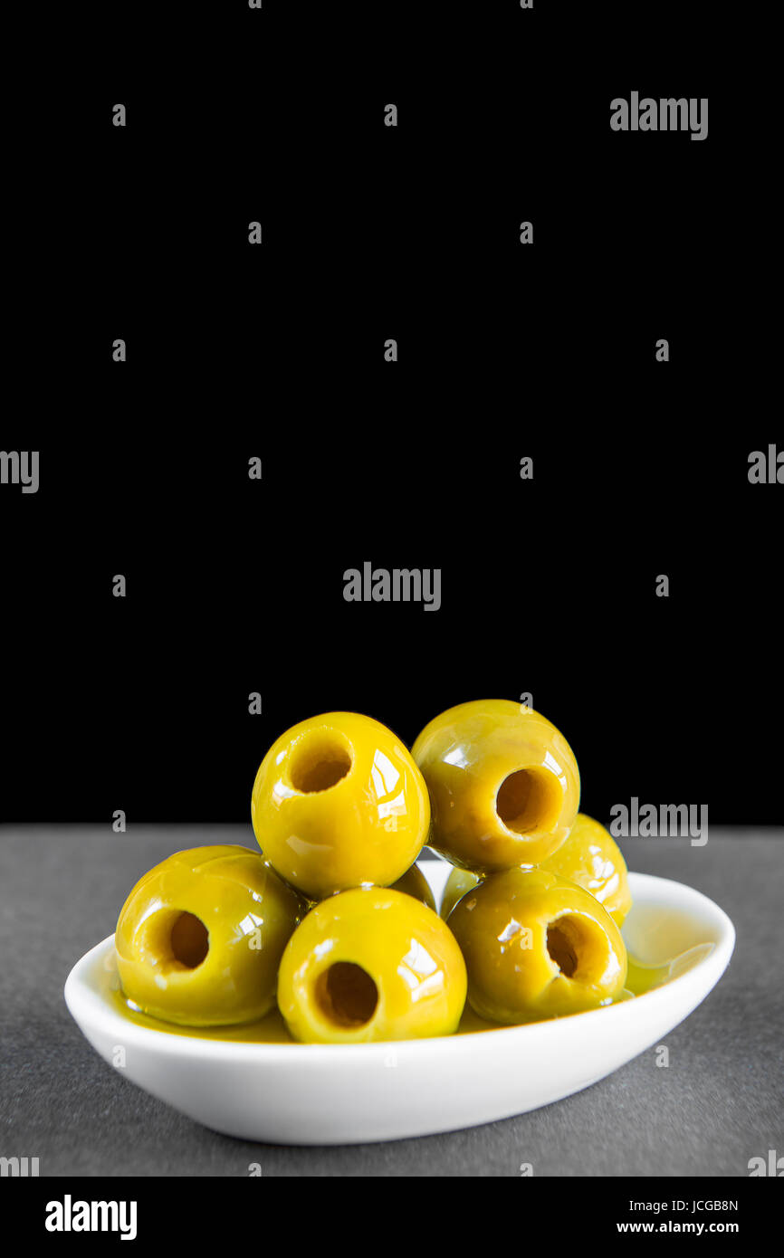 Green pitted olives with olive oil for a good snack Stock Photo Alamy