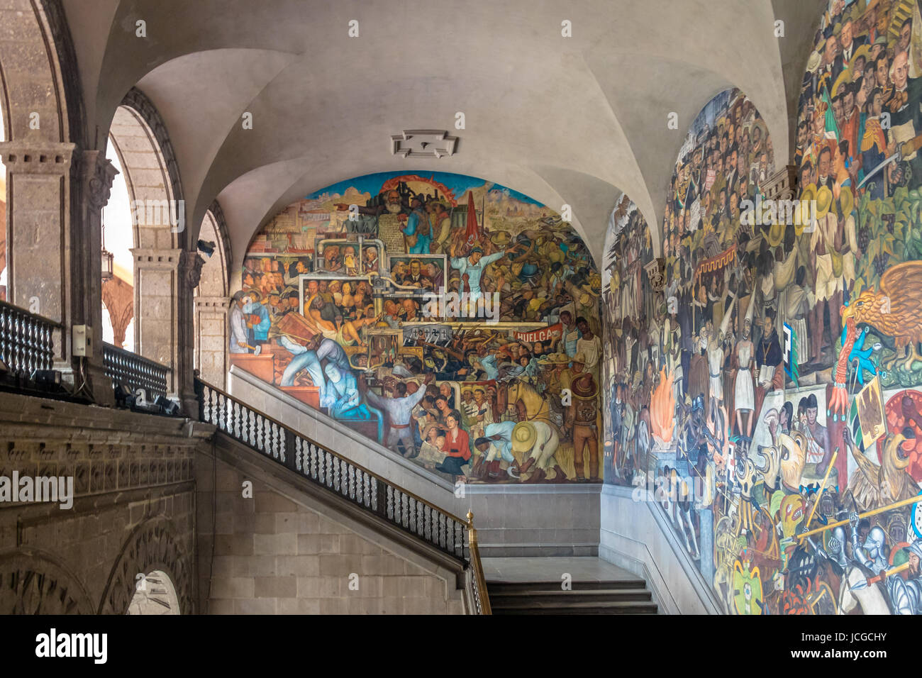 The stairs of National Palace with the famous mural 'Class Struggle' and 'The History of Mexico' by Diego Rivera - Mexico City, Mexico Stock Photo