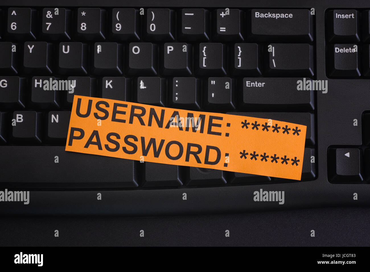 Paper note with Username and Password on black computer keyboard. Internet security concept. Close up. Stock Photo