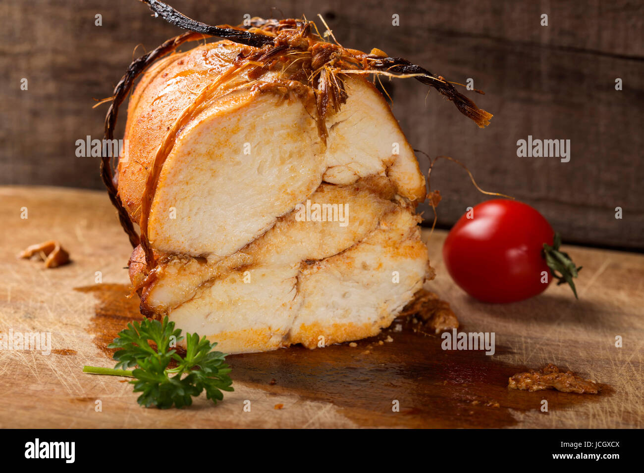 Close up of homemade juicy chicken pastrami on wooden background Stock Photo