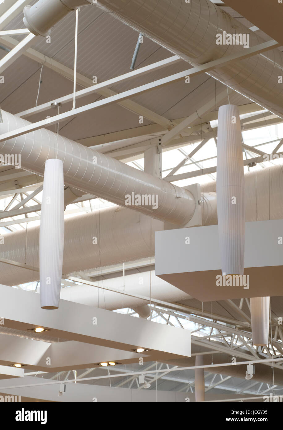 White Painted Heating Ducts In Ceiling Of Garden Centre Stock