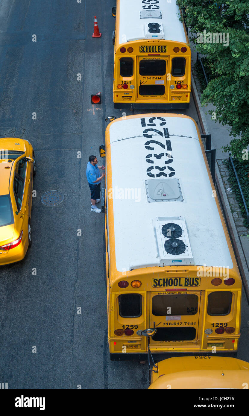New York City school buses with one driver talking to another Stock Photo