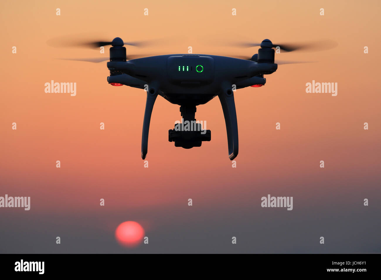 Remote controlled drone flying in air and sunset sky Stock Photo Alamy