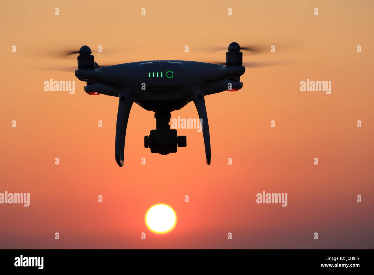 Remote controlled drone flying in air and sunset sky Stock Photo Alamy