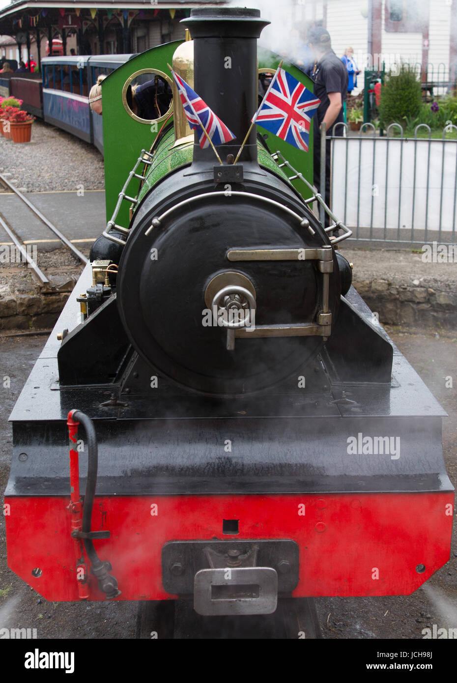 Ravenglass and Eskdale Railway Steam Engine River Irt stands on the turntable at Ravenglass Station. Union Jack Flags are displayed. Stock Photo