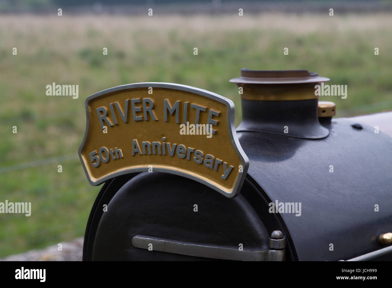 Ravenglass and Eskdale Railway Steam Engine River Mite carried an apropriately sized headboard to mark its 50th anniversary year. Stock Photo