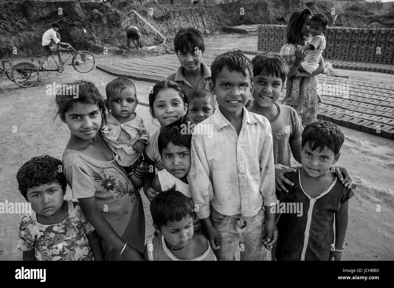 AMRITSAR, PUNJAB, INDIA - 21 APRIL 2017 : monochrome picture of Indian kids holding their younger siblings Stock Photo