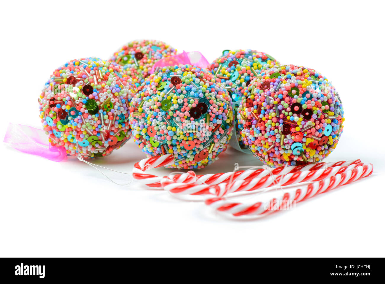 Multicolored christmas balls and candy canes isolated on white Stock
