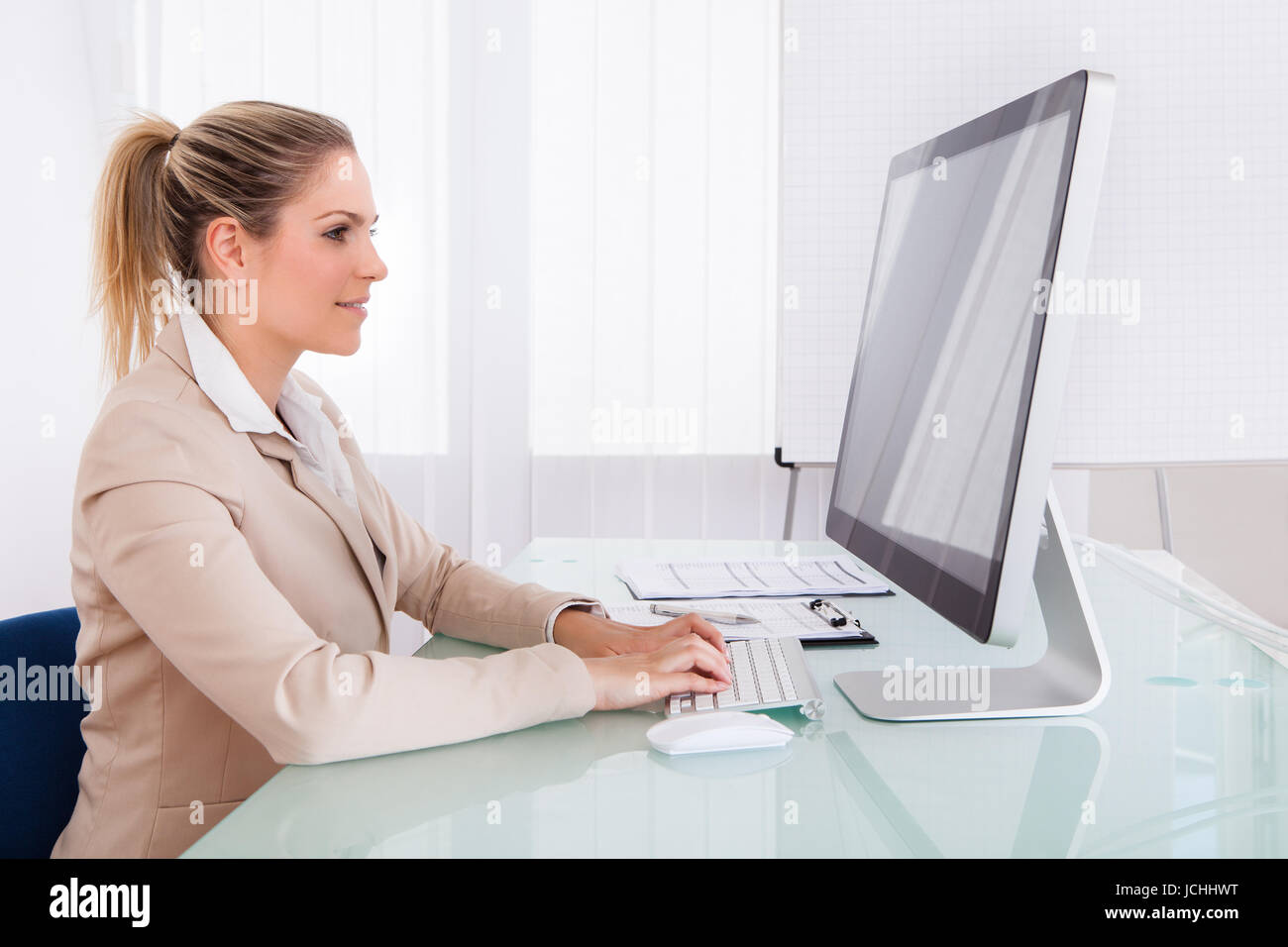 Portrait Of Young Businesswoman Using Computer In The Office Stock ...