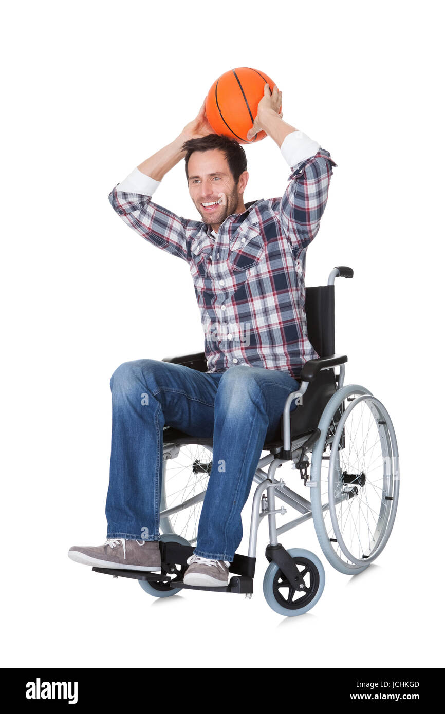 Man in wheelchair with basketball. Isolated on white Stock Photo