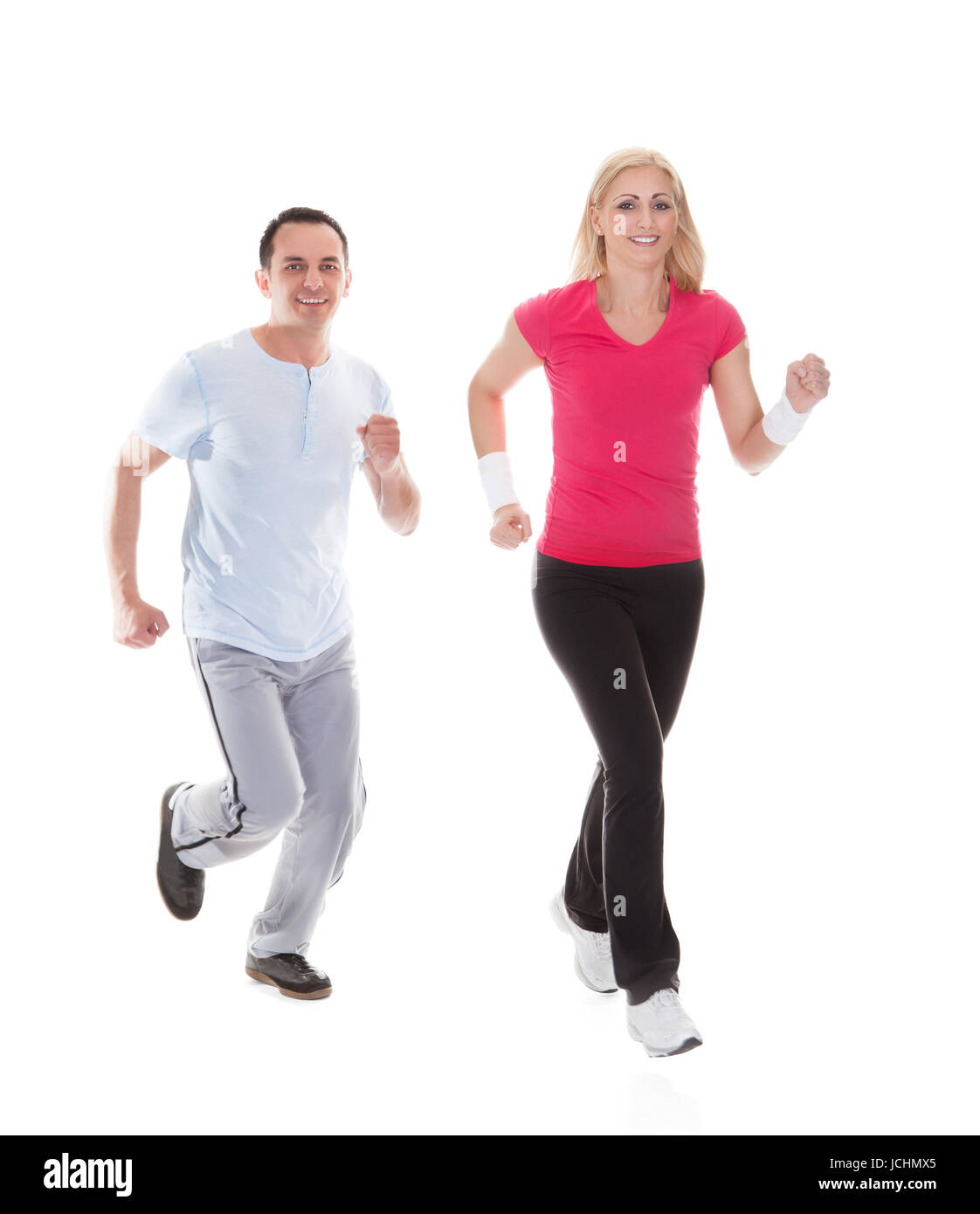 Fitness couple running towards camera. Isolated on white Stock Photo