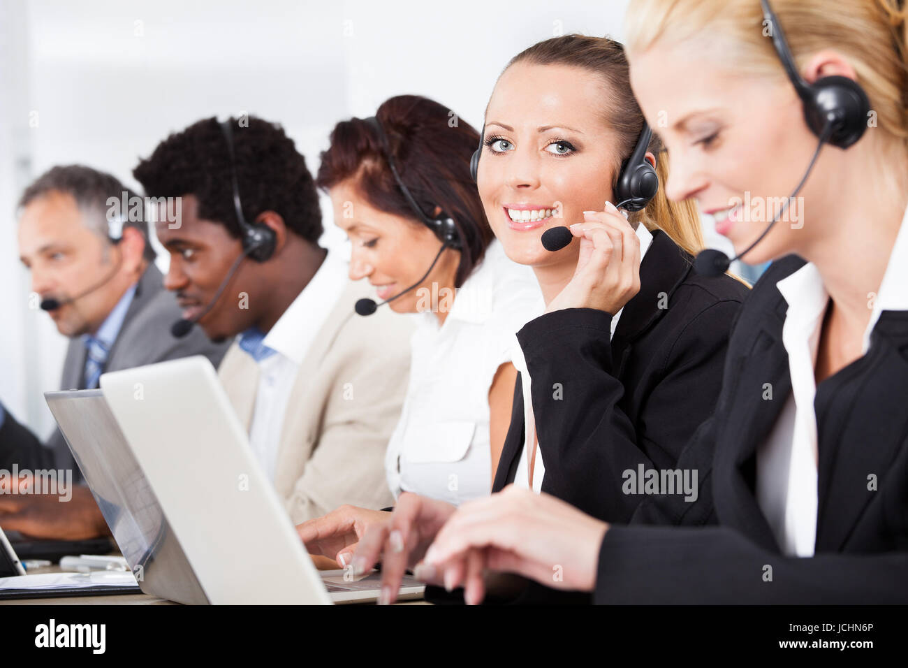 Happy Co-workers Wearing Headsets Working In Call Center Stock Photo ...