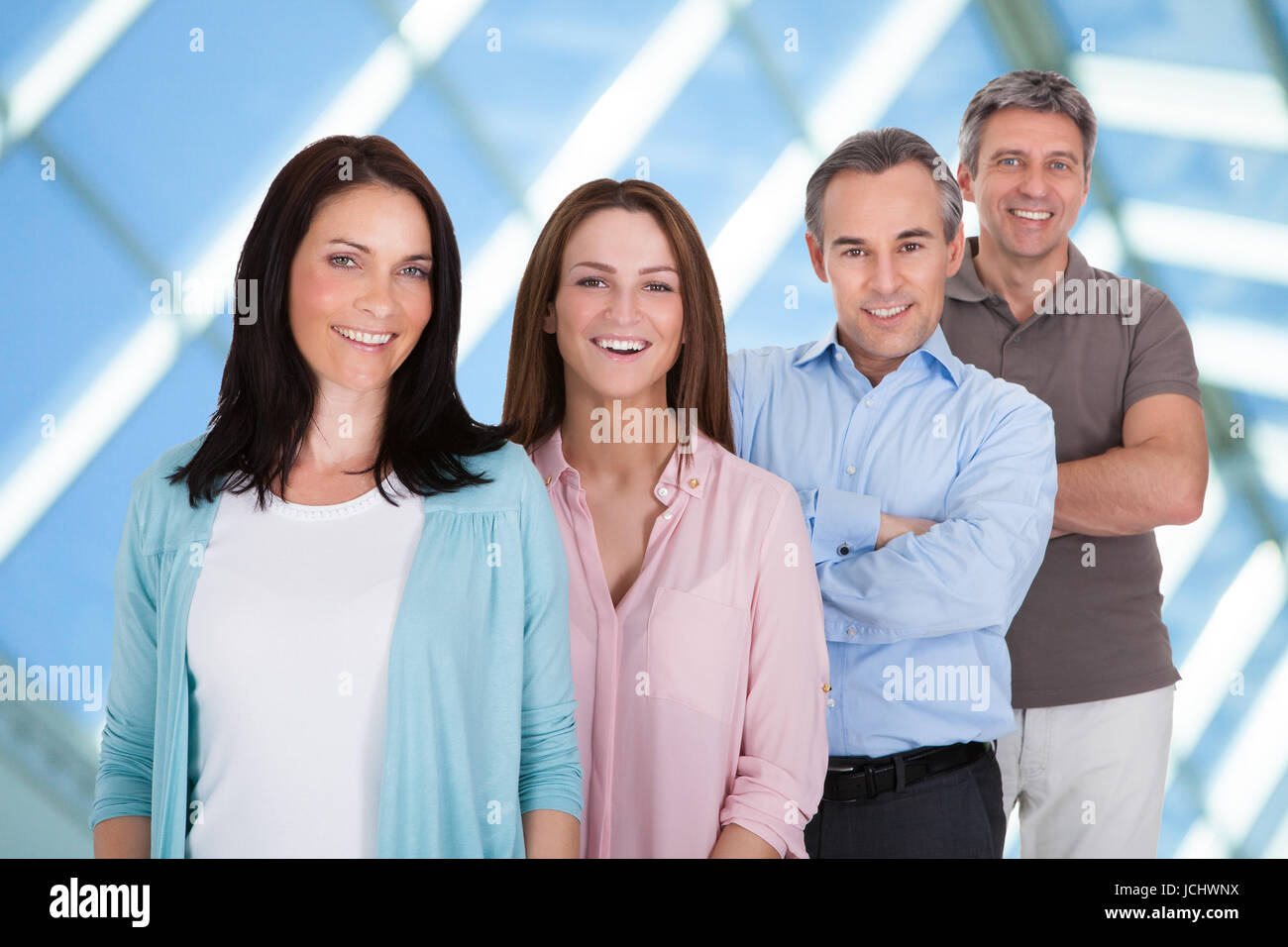 Group Of Happy Businesspeople Standing In Row Stock Photo - Alamy