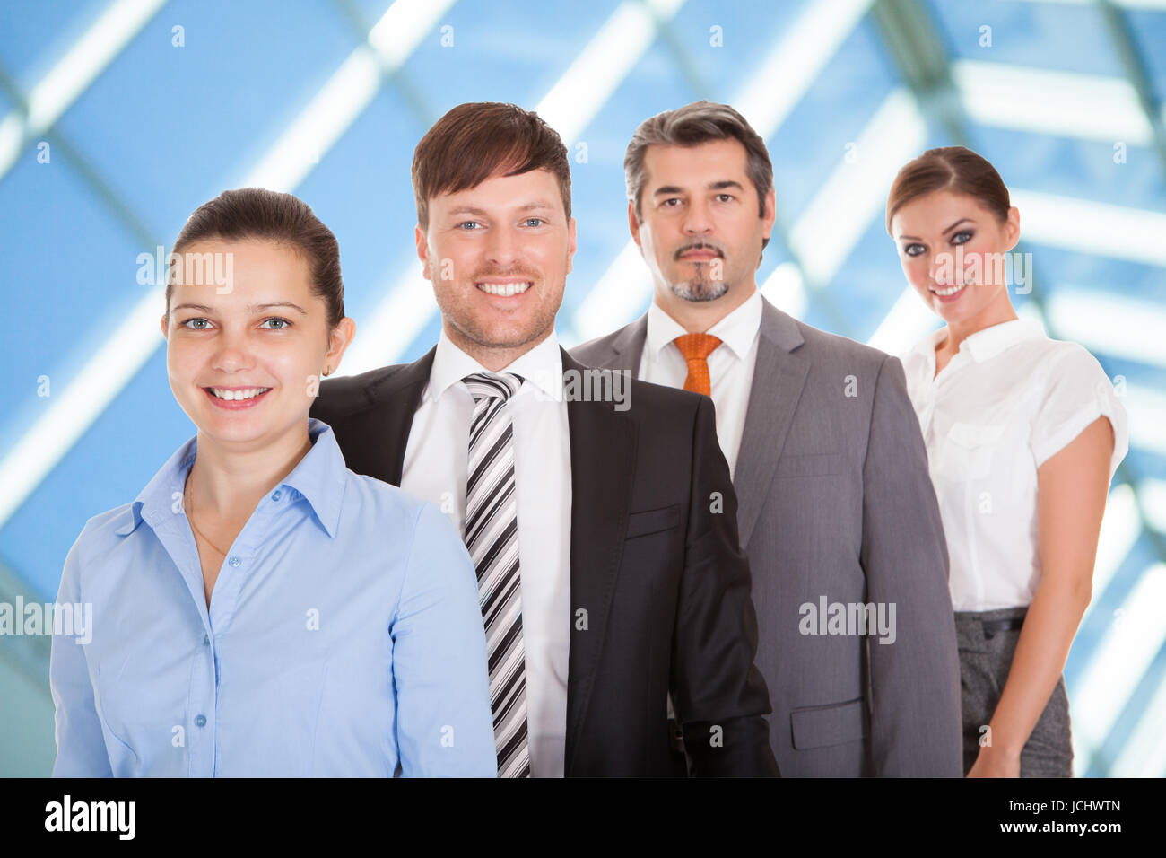 Group Of Confident Businesspeople Standing In A Row Stock Photo - Alamy