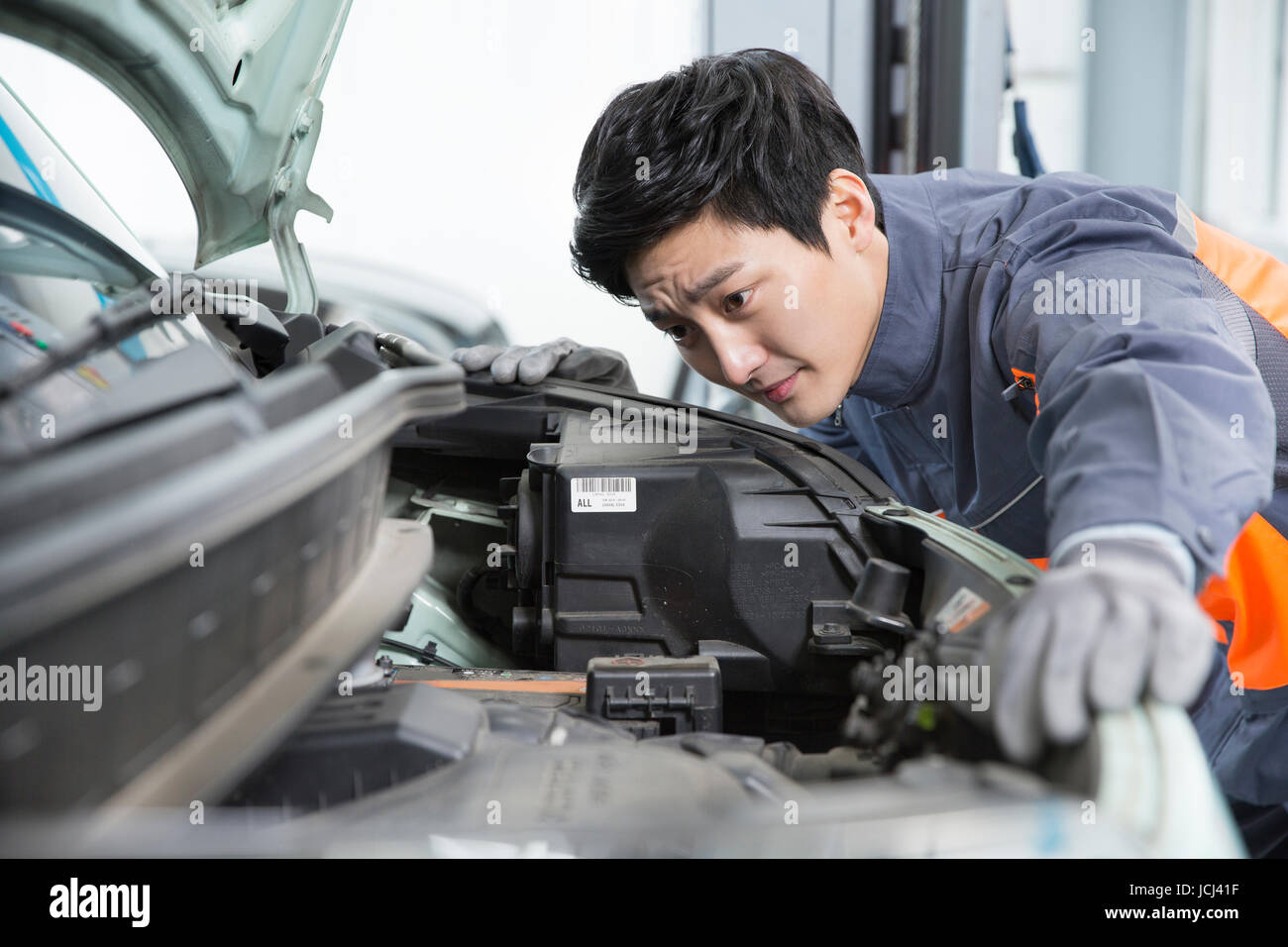 Portrait of young car mechanic repairing a car Stock Photo - Alamy