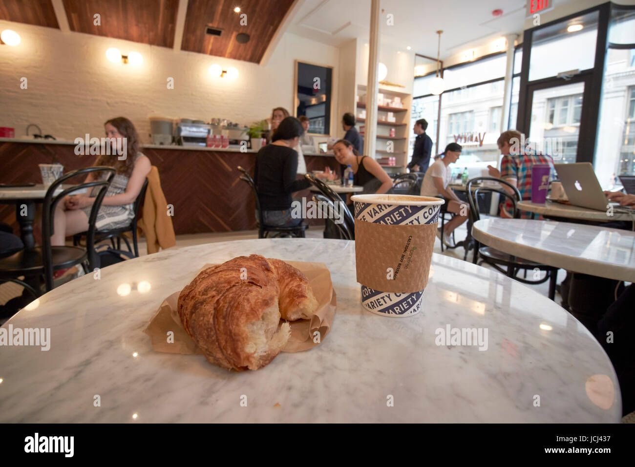 coffee and a croissant in an artisan coffee shop New York City USA