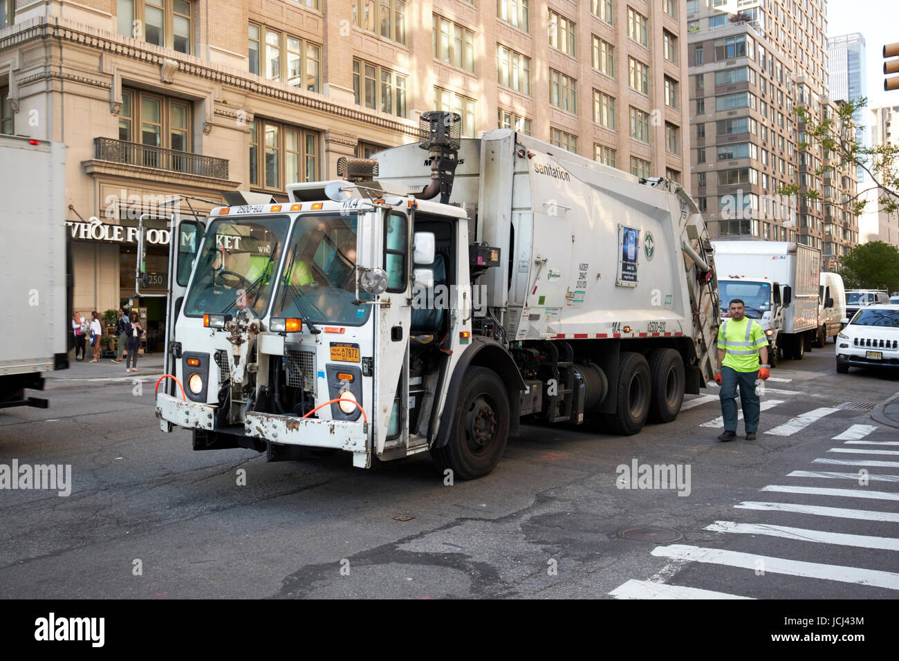 New York City sanitation truck emptying street bins new york streets